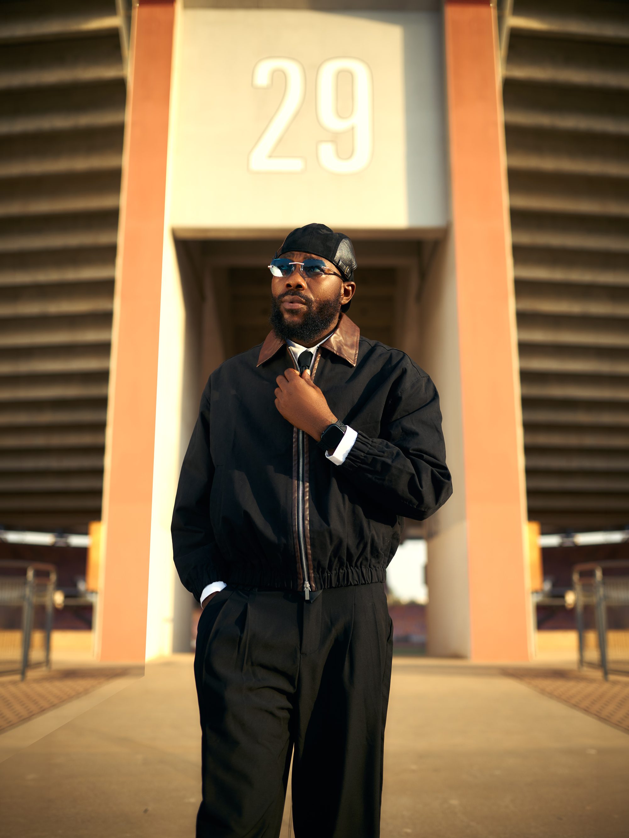 DJ Romie standing in dramatic golden light
