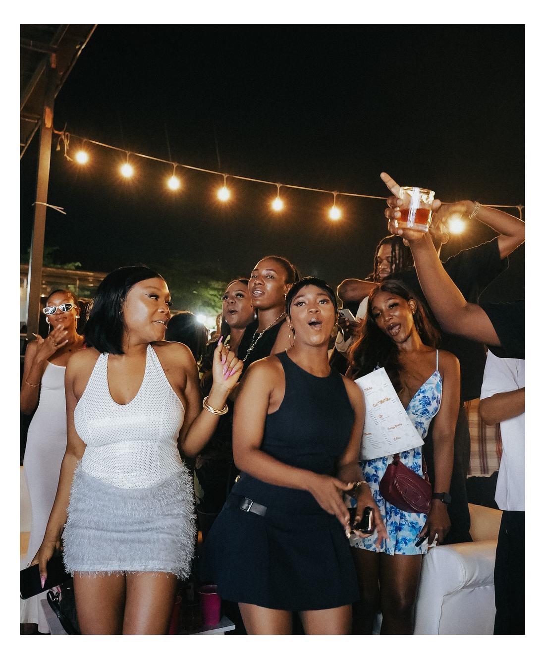A group of friends singing along at Romie's Block